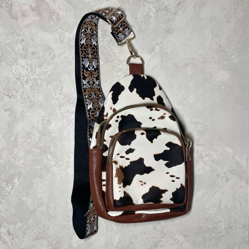 NWOT Alba cow print sling back bag